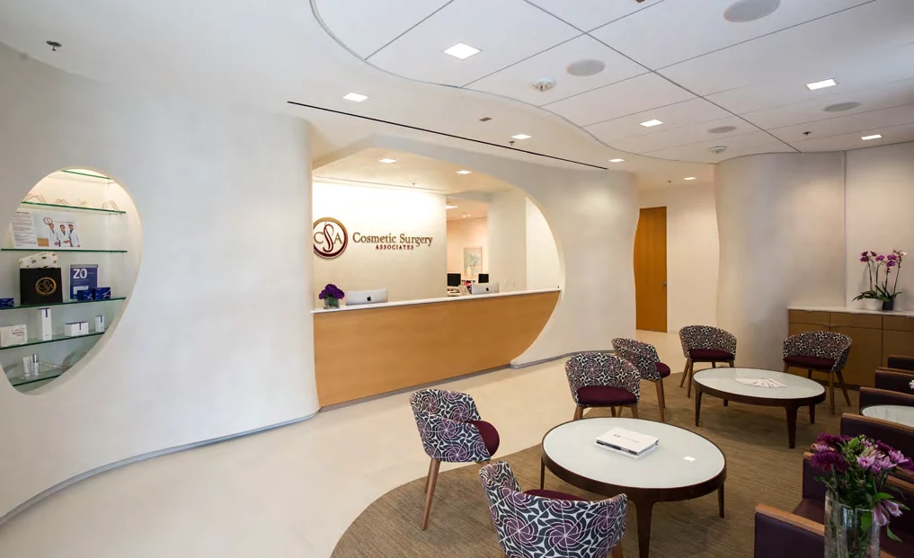 Curved reception desk and patient waiting area at Cosmetic Surgery Associates