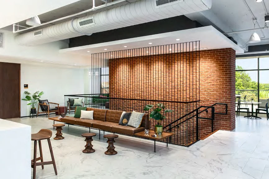 Brick feature wall, wood ceiling, and communal lounge at 277 South Washington Street
